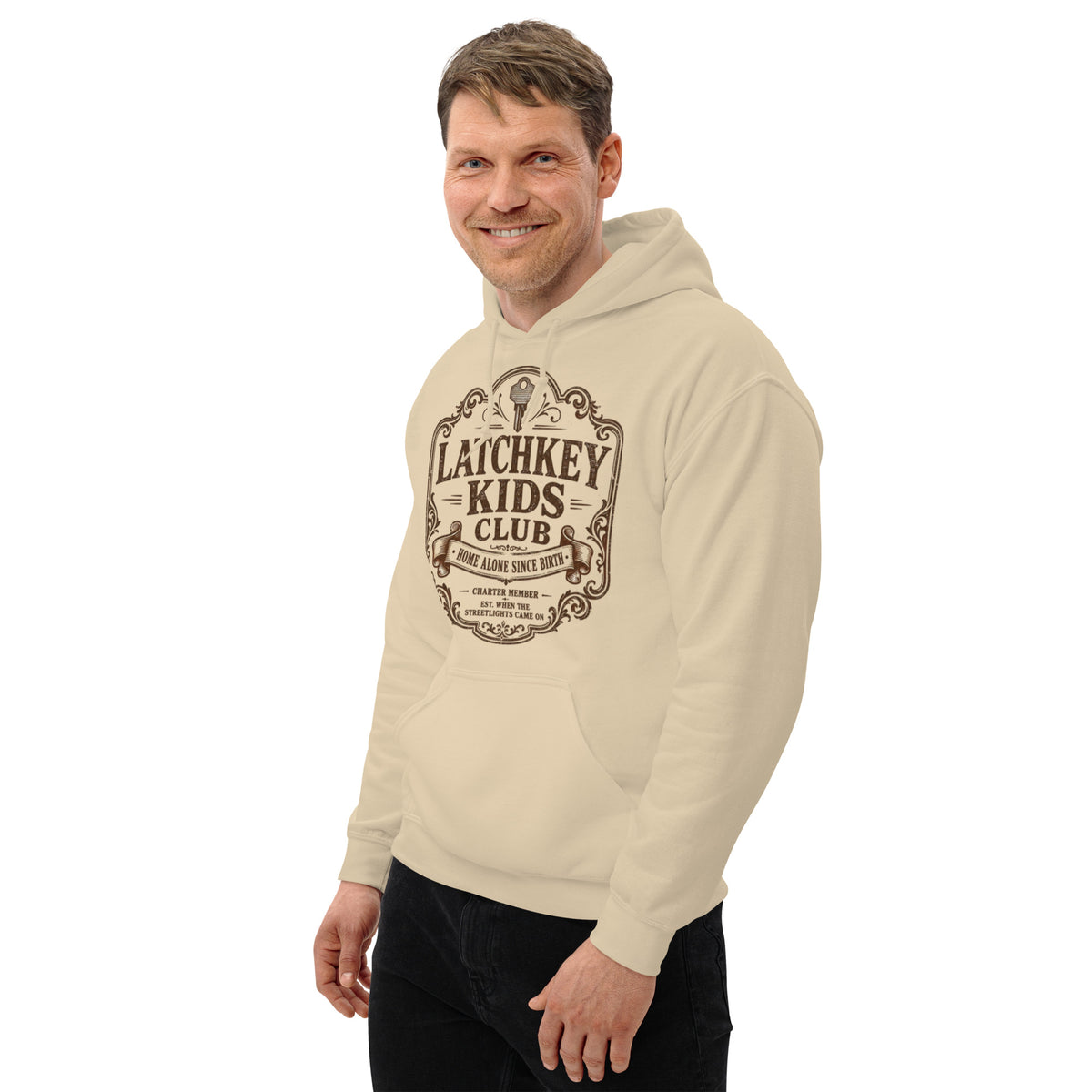 Man smiling and modeling the Latchkey Kids Club retro graphic pullover hoodie outdoors