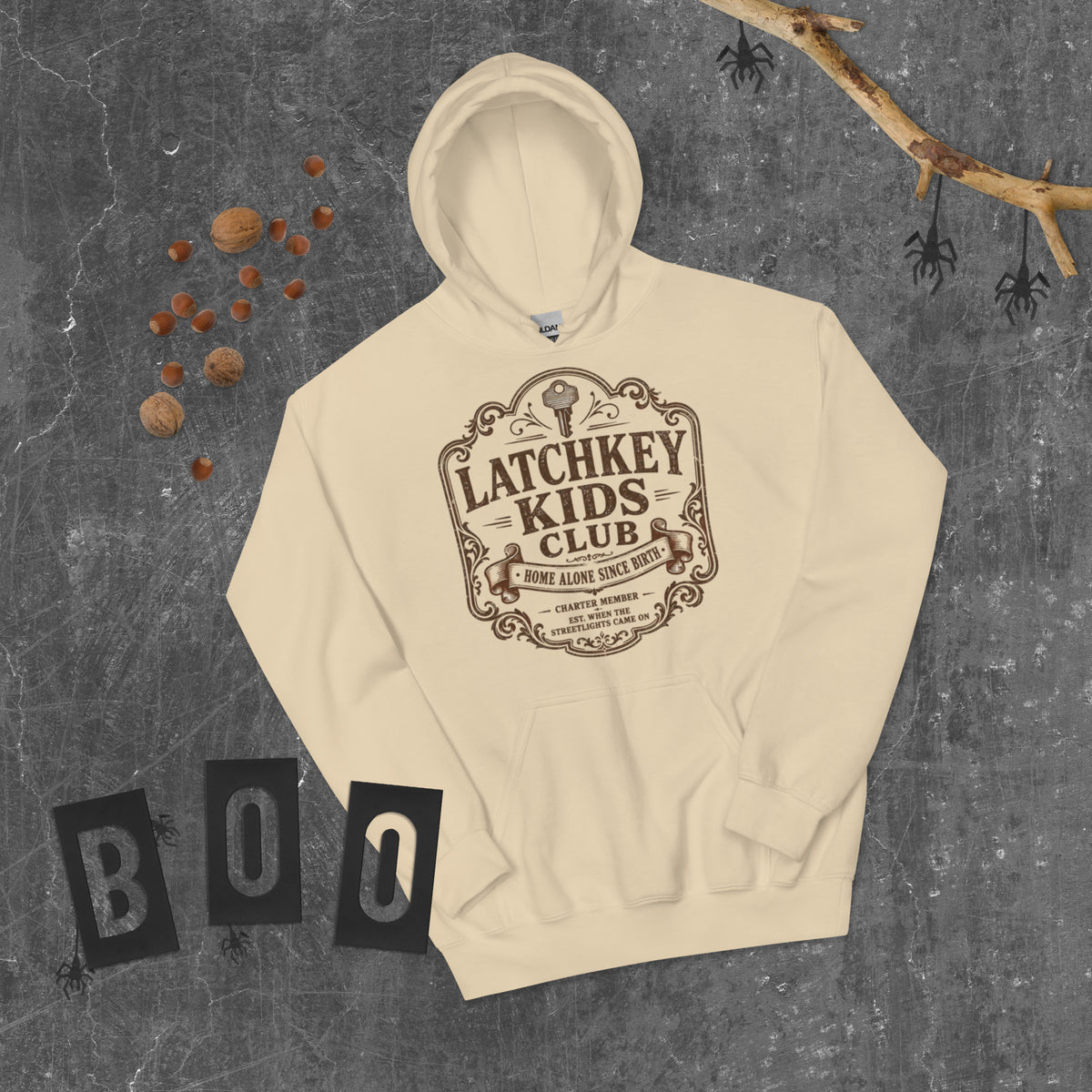 Overhead flat lay of Latchkey Kids Club retro hoodie on a wood background