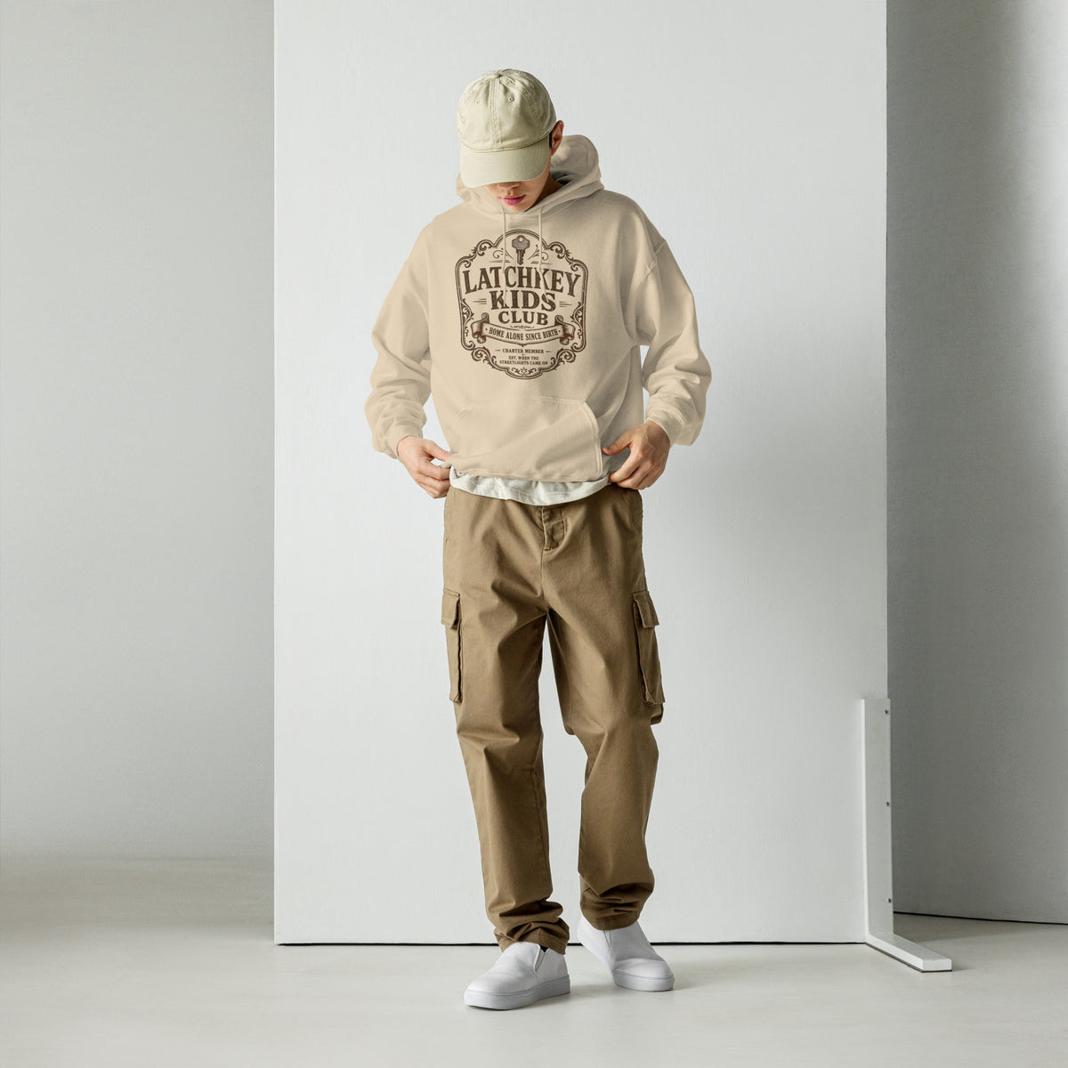 Side angle view showing the sleeve cut and fit of the Latchkey Kids Club unisex hoodie