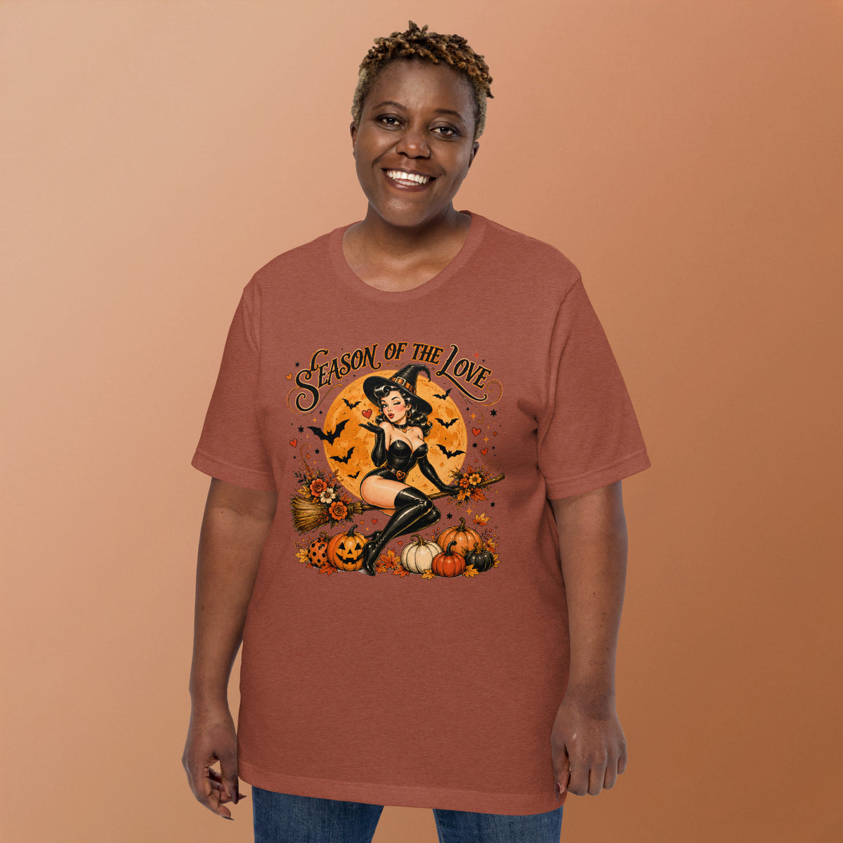 Female model smiling and wearing Season of the Witch vintage Halloween graphic t-shirt in heather clay