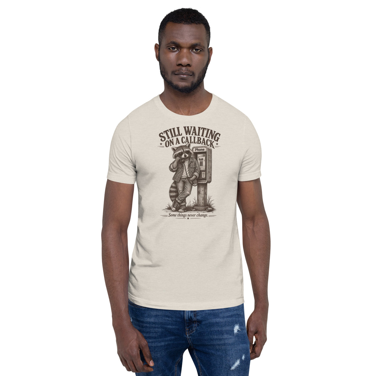 Male model standing and wearing Still Waiting on a Callback funny raccoon graphic t-shirt in heather dust
