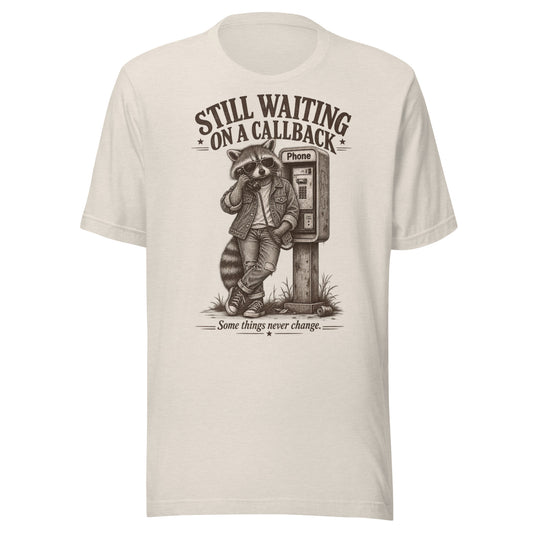 Front view of Still Waiting on a Callback funny raccoon graphic t-shirt in beige