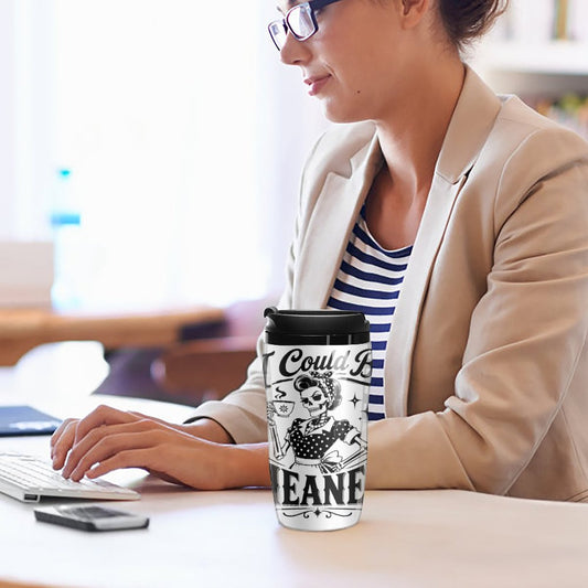 Person working on a computer with a coffee mug featuring text and graphics.