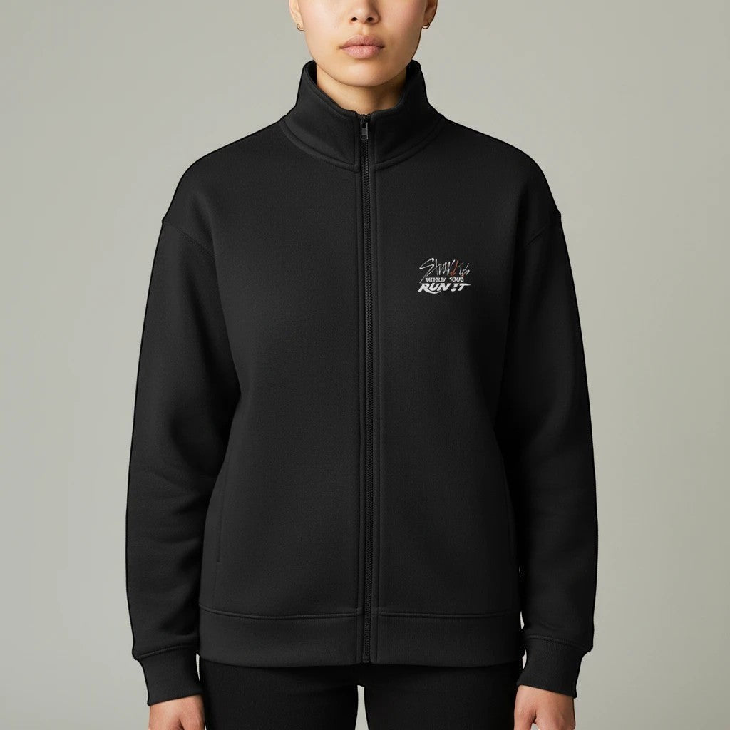 Clothing By Hot Takes Designs black Stray Kids Run It track jacket with full zip and chest logo on a model