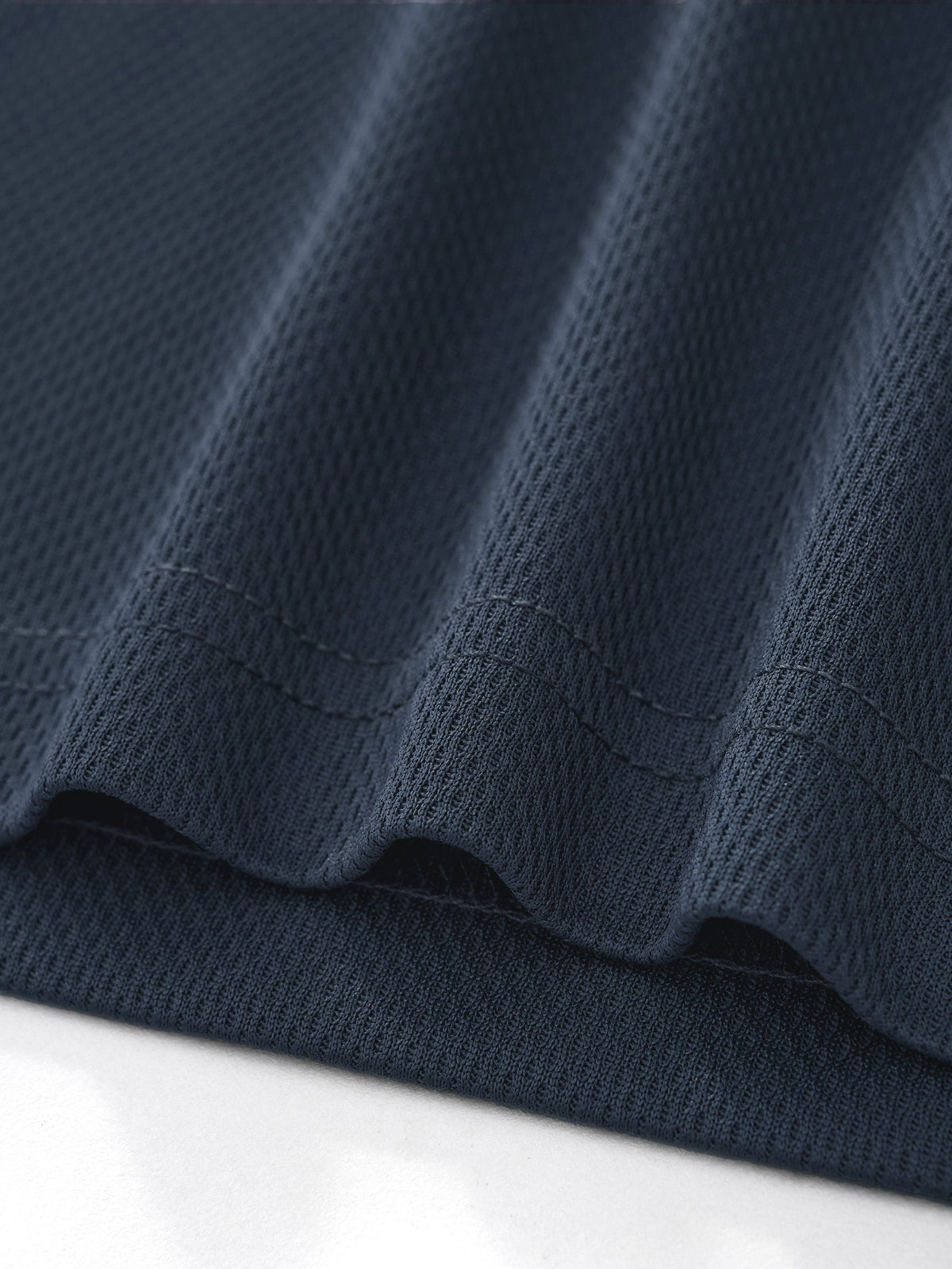 Clothing By Hot Takes Designs dark blue moisture-wicking polyester jersey fabric with a textured mesh finish.