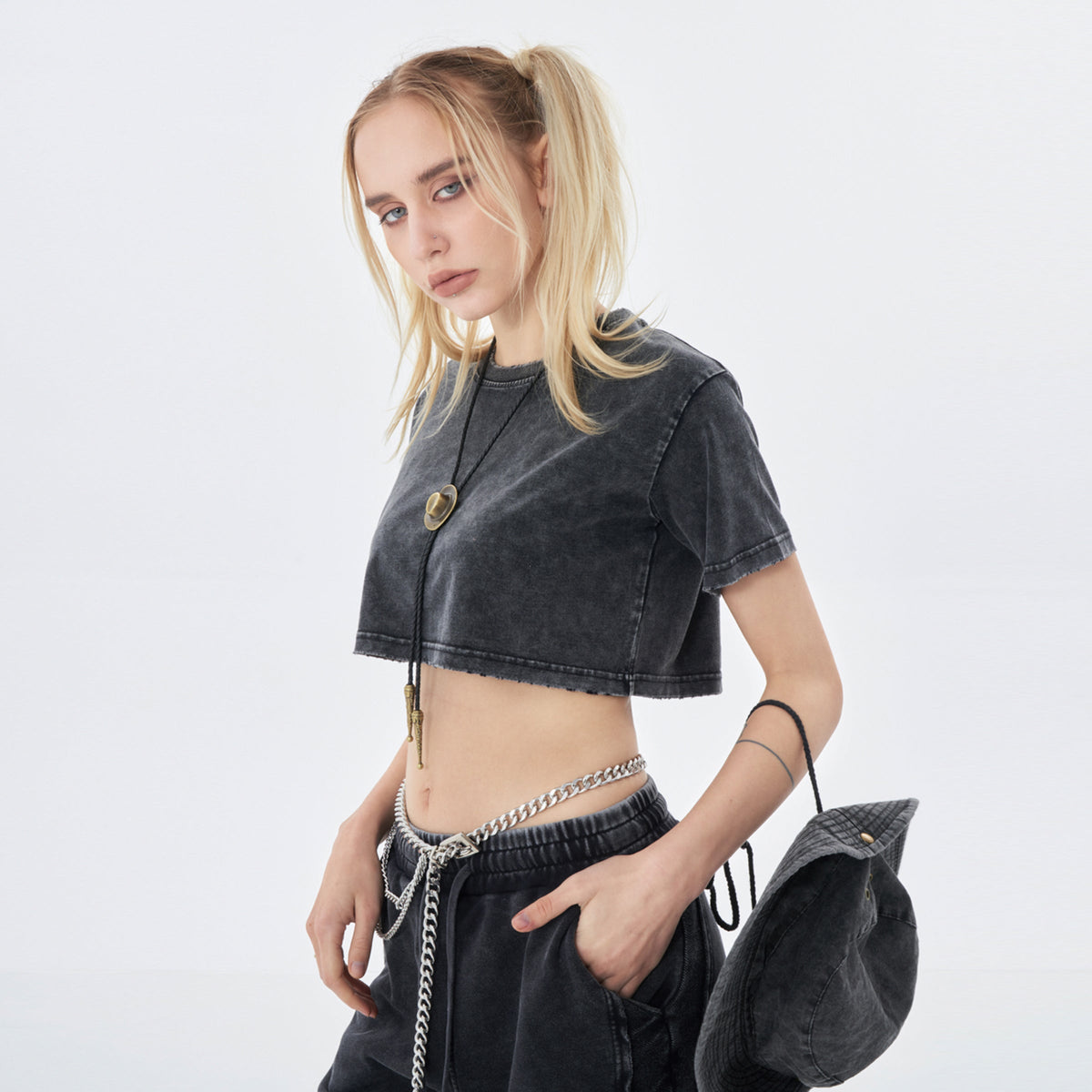 Clothing By Hot Takes Designs vintage wash distressed black cropped cotton t-shirt worn by a blonde model