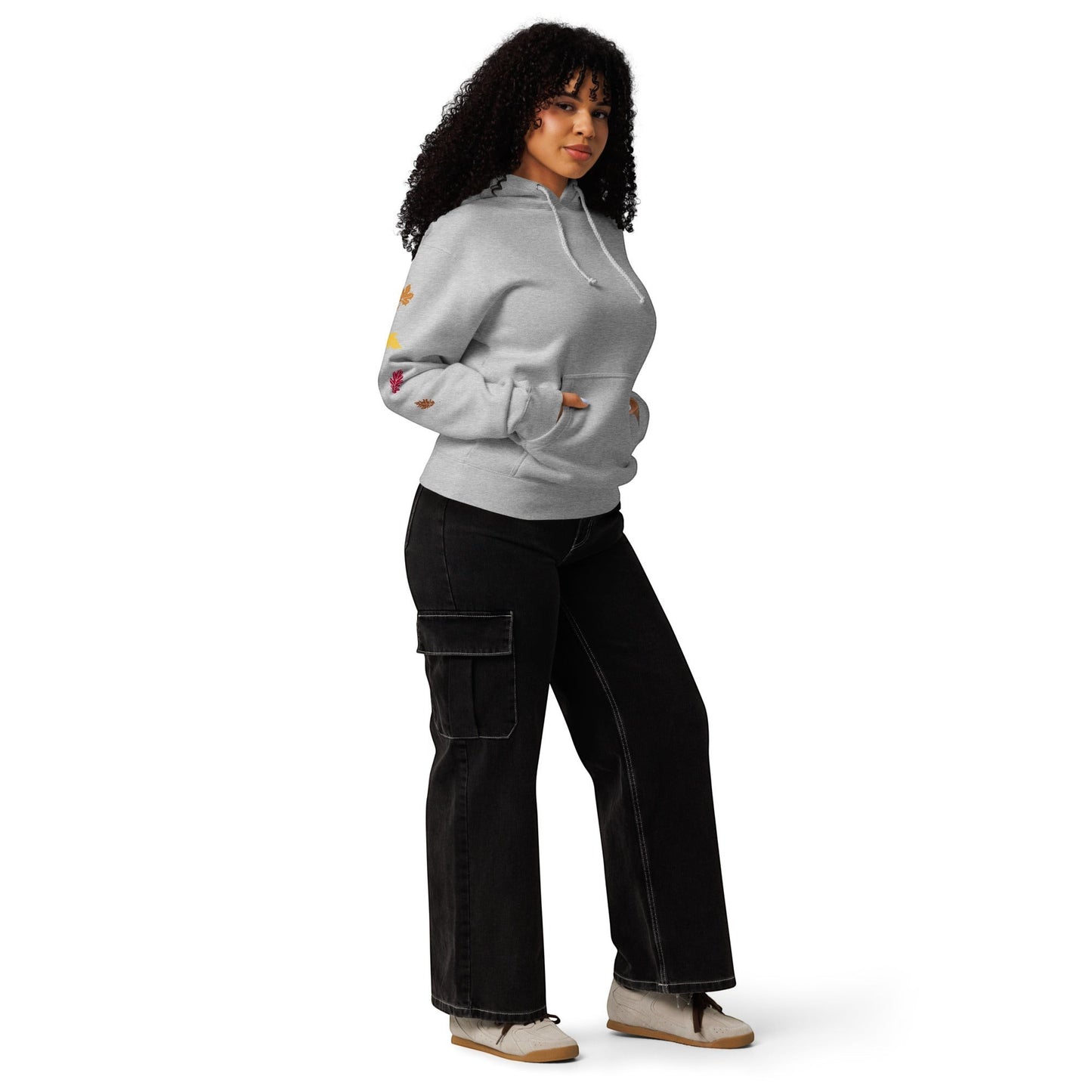 Clothing By Hot Takes Designs grey heavyweight fleece hoodie with fall leaf sleeve detail worn by a curly-haired model