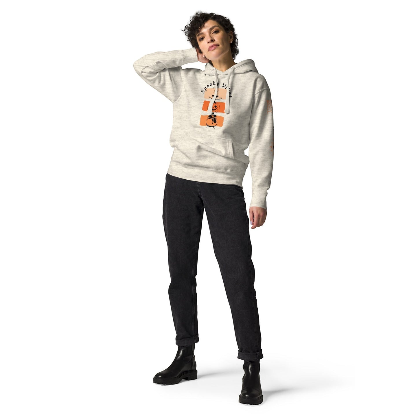 Clothing By Hot Takes Designs retro Halloween hoodie with pumpkin graphic on a woman wearing black jeans and boots.