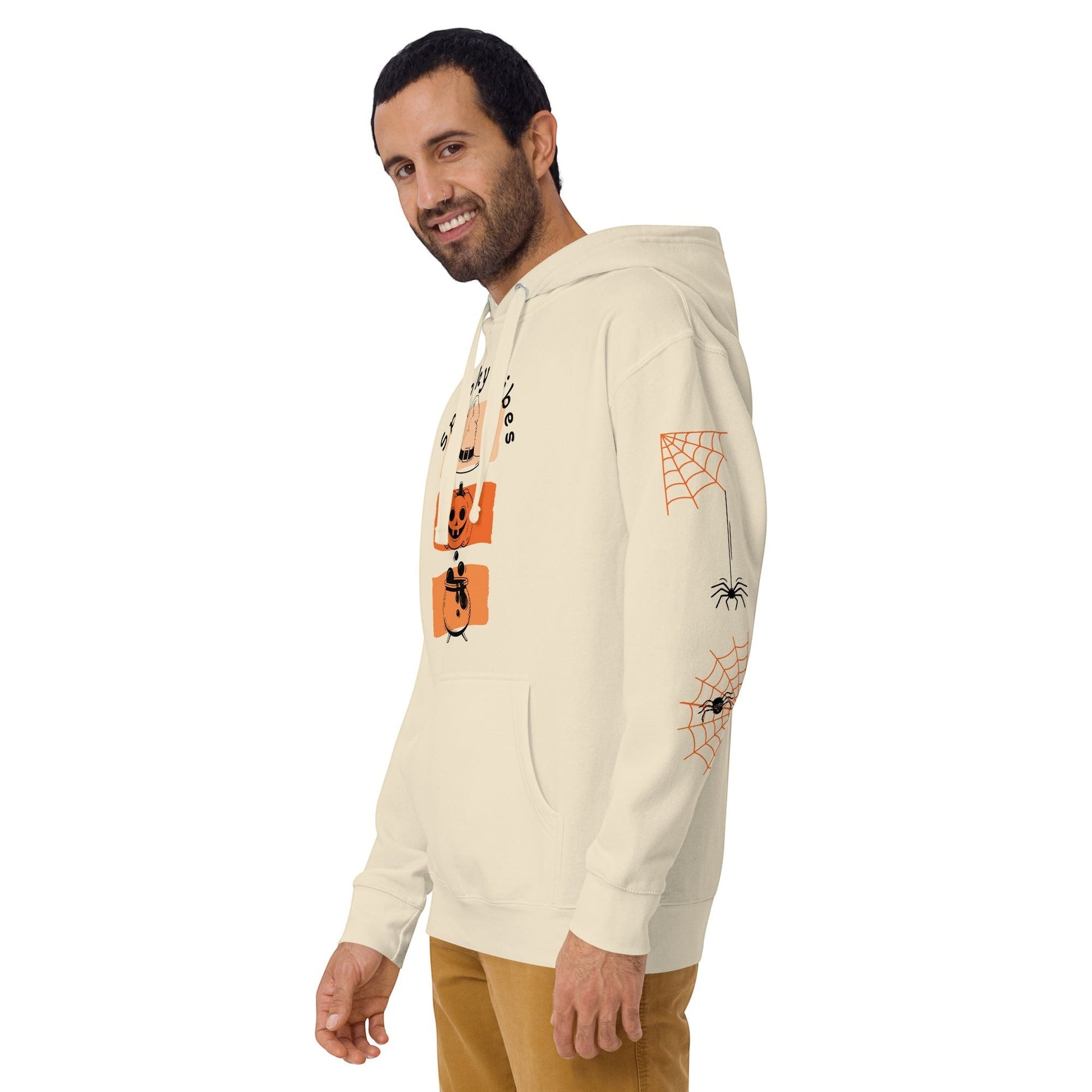 Clothing By Hot Takes Designs cream hoodie with retro pumpkin graphic and spider web sleeve print worn by a man