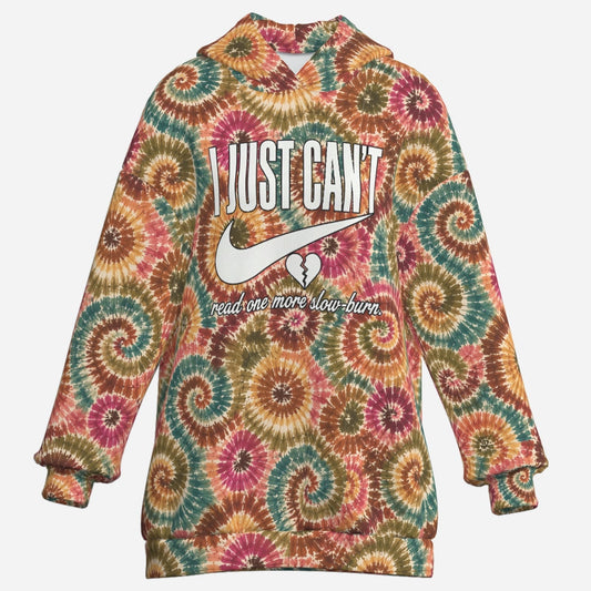 Front view of oversized earth-tone spiral tie-dye hoodie dress featuring bold Just Can't BookTok quote graphic
