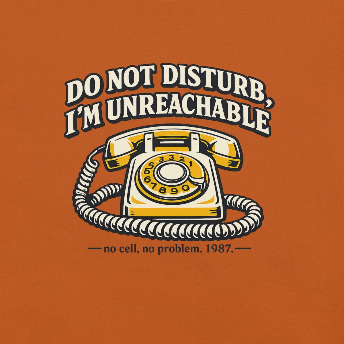 Square flat lay view of an autumn rust orange t-shirt featuring the yellow rotary telephone graphic and text Do Not Disturb I'm Unreachable
