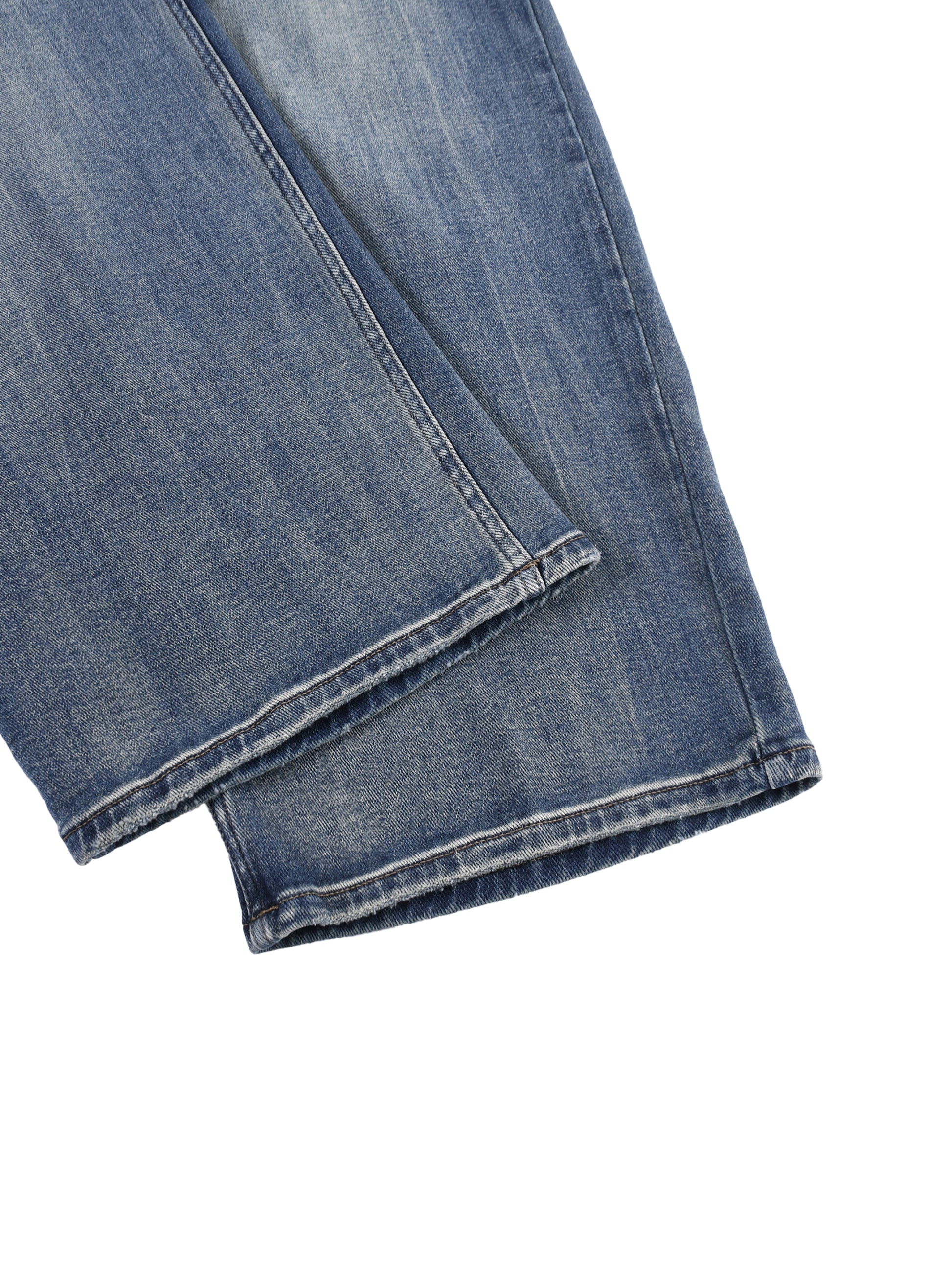 Close-up view of the front pocket layout and a folded wide-leg hemline on the blue ATEEZ sun-fade heavyweight denim jeans.