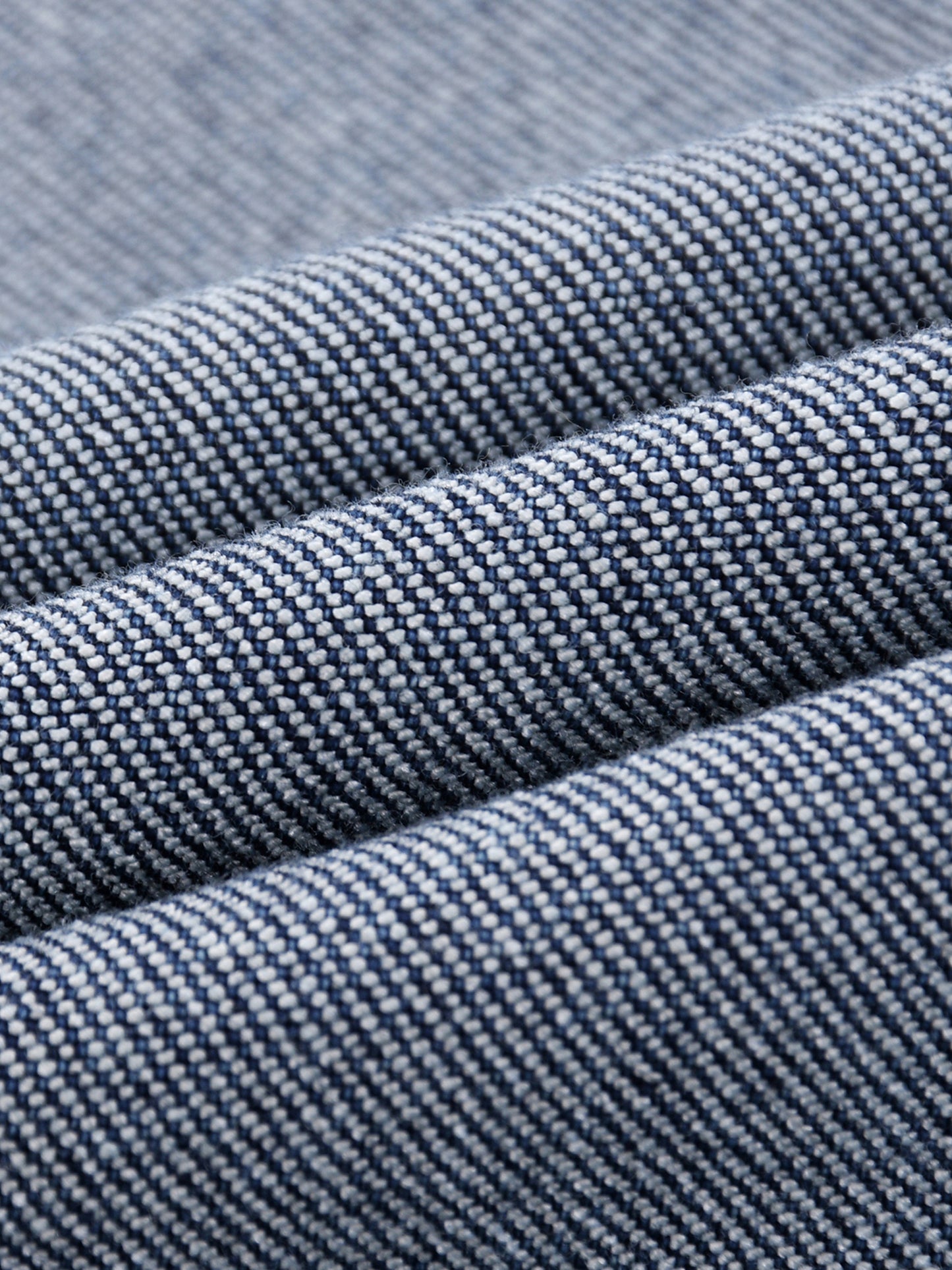 acro close-up view of the diagonal twill weave pattern and premium cotton-blend fibers of the BT21 King TATA denim jeans.