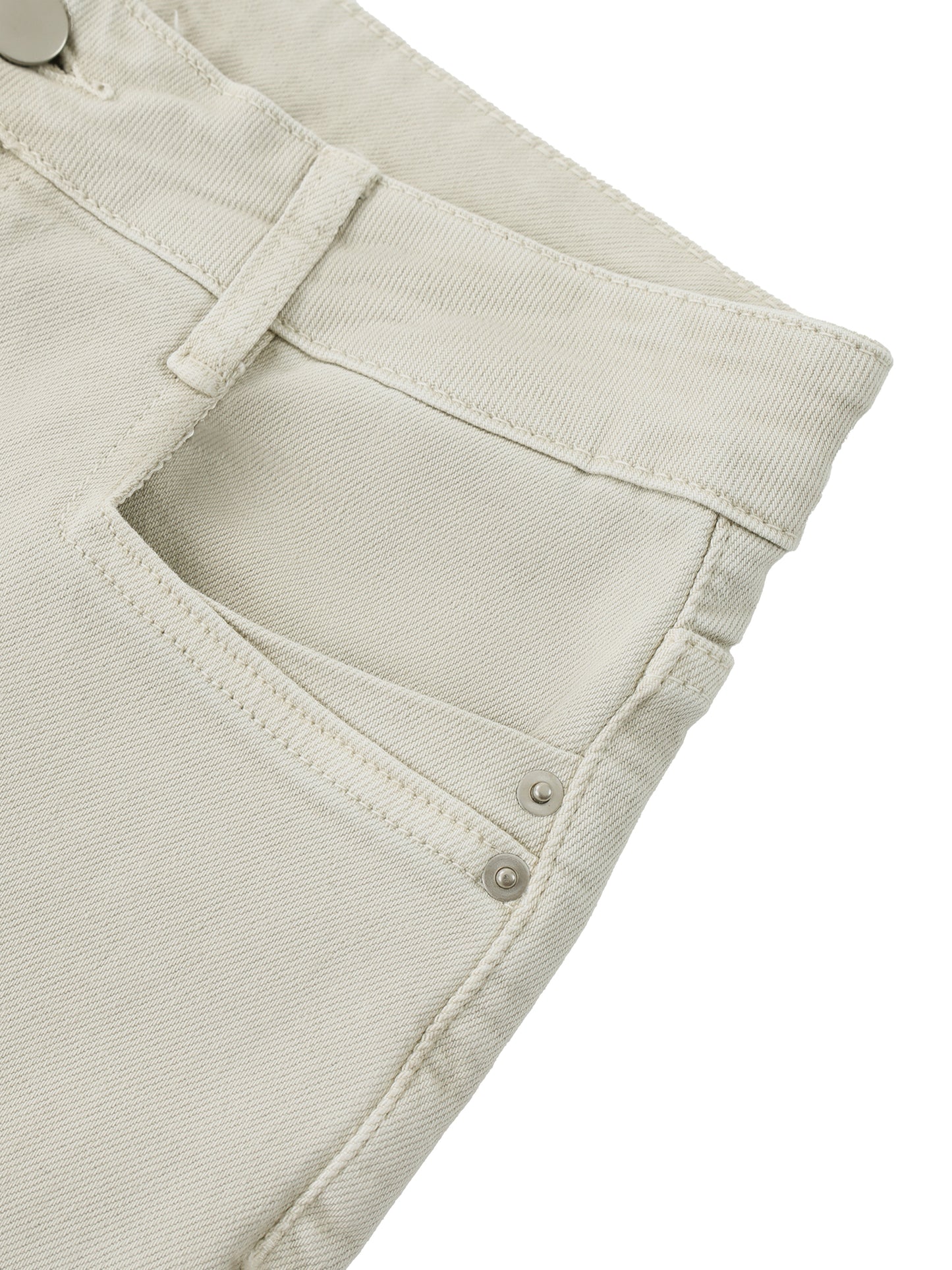 Close-up detail of the premium handcrafted distressing, pocket layout, and heavy cotton fabric on women's beige vintage flare jeans.