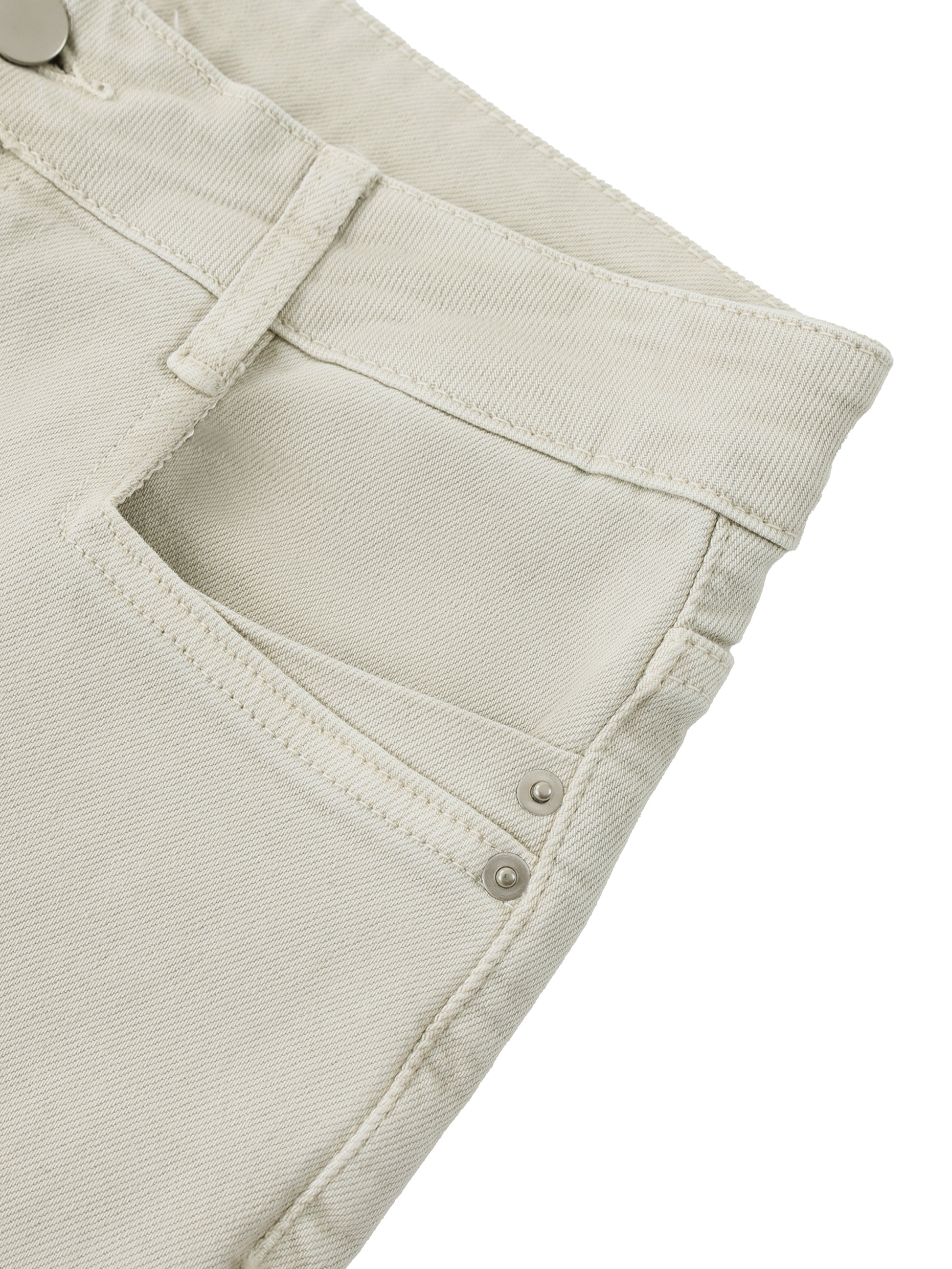 Close-up detail of the premium handcrafted distressing, pocket layout, and heavy cotton fabric on women's beige vintage flare jeans.
