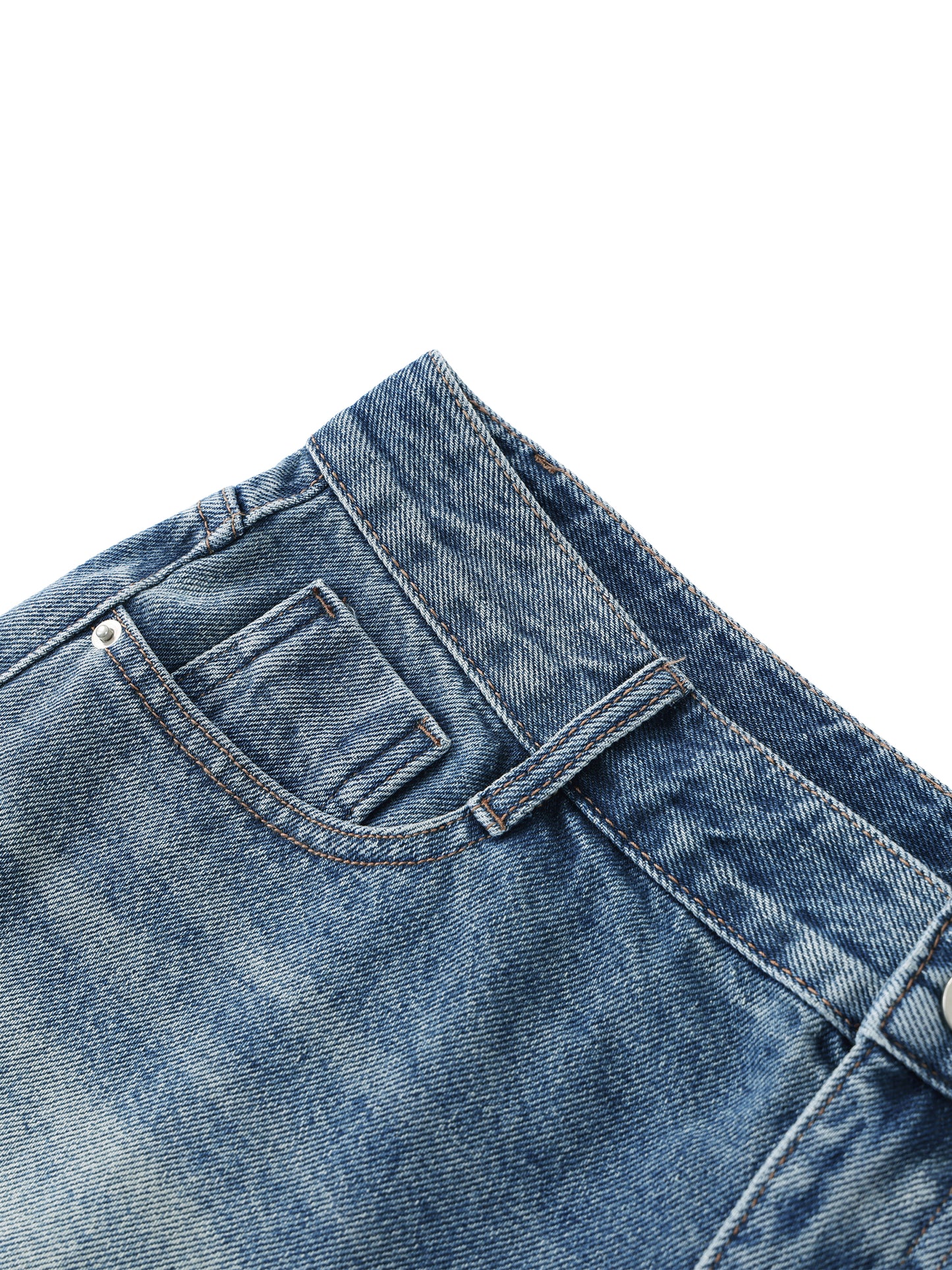 Close-up view of the front coin pocket, metal rivets, and double-stitching details on premium blue vintage wash raw hem denim shorts.