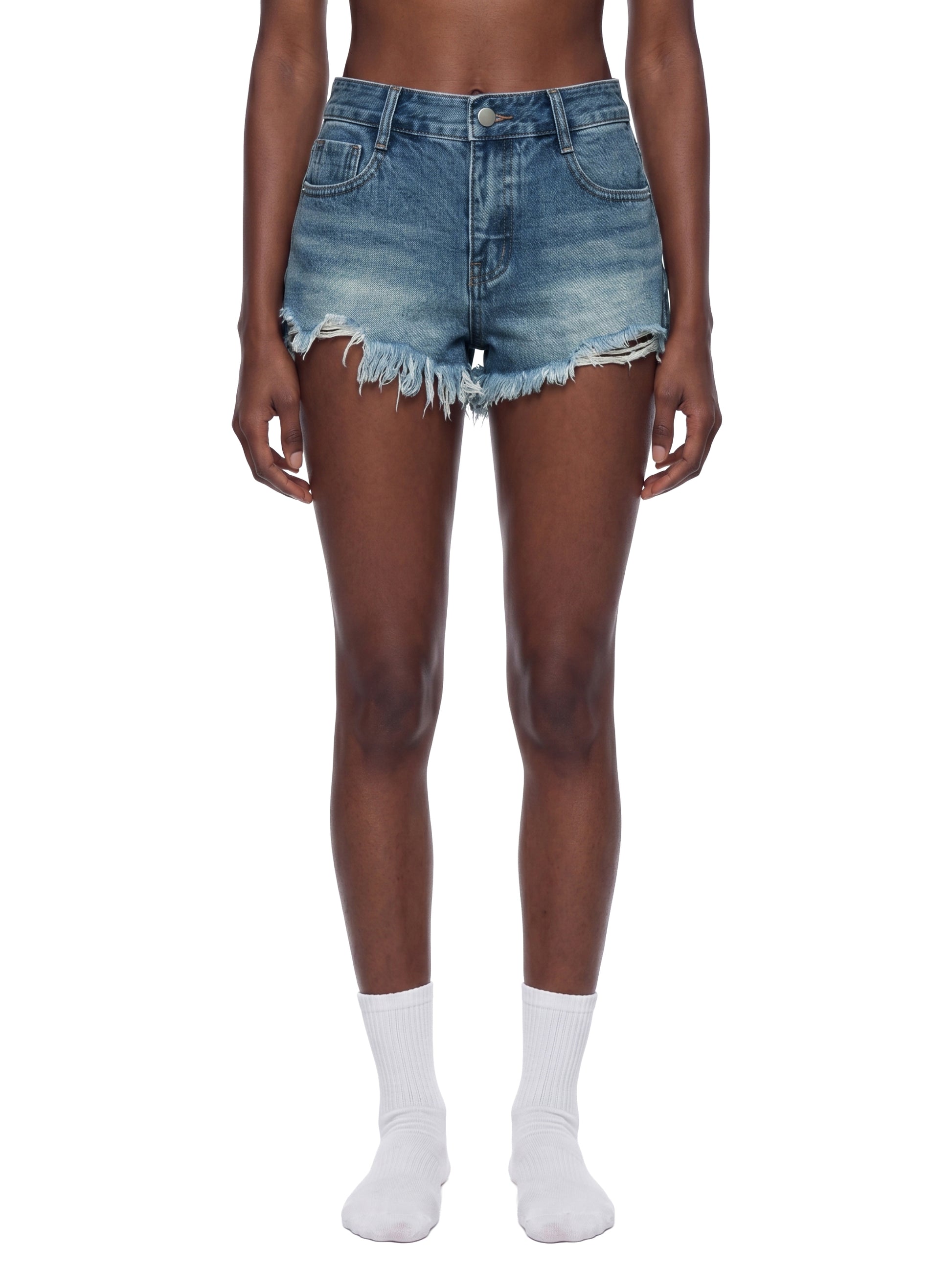 Front view of a model wearing the blue BTS vintage wash raw hem denim shorts, showcasing the high-waisted fit, short crop length, and summer streetwear styling.