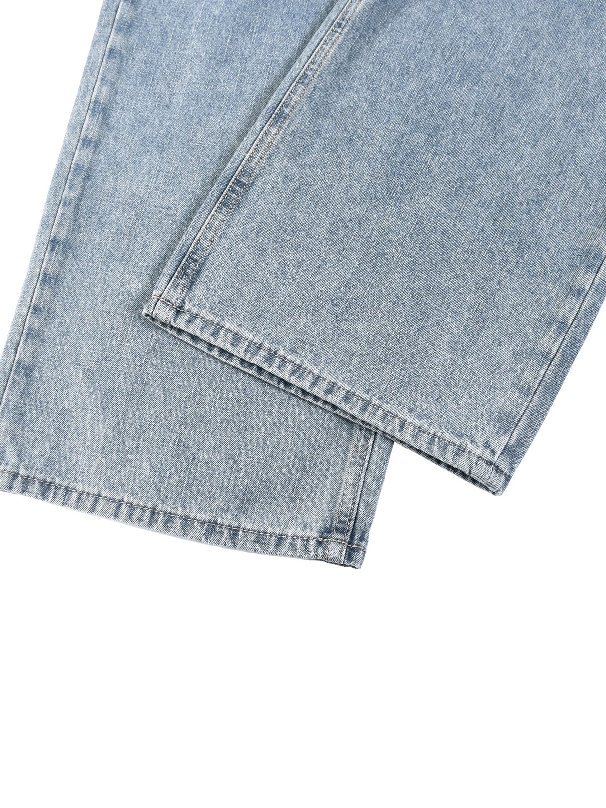 Close-up view of the clean side seam and durable hem stitching on unisex light gray vintage wash straight leg jeans.