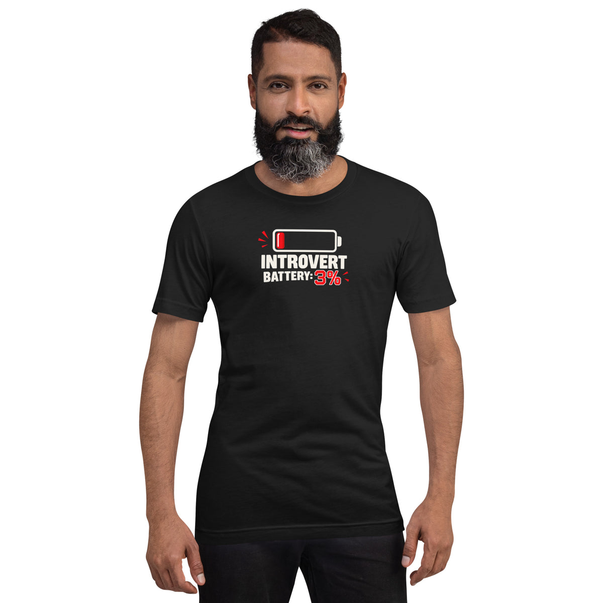 Front view of a bearded male model wearing a vintage black unisex t-shirt featuring a low battery icon and graphic reading Introvert Battery: 3%