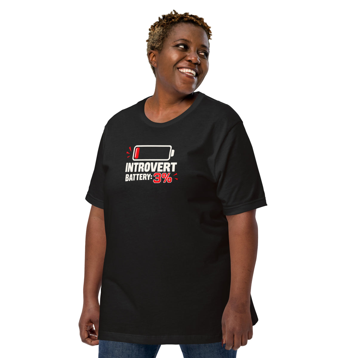 Front view of a smiling female model wearing a vintage black unisex t-shirt featuring a low battery icon and graphic reading Introvert Battery: 3%
