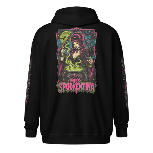 Back view of a black unisex heavy blend zip hoodie featuring a vintage gothic witch brewing a cauldron with banner reading Miss Spookentina and floral sleeve prints