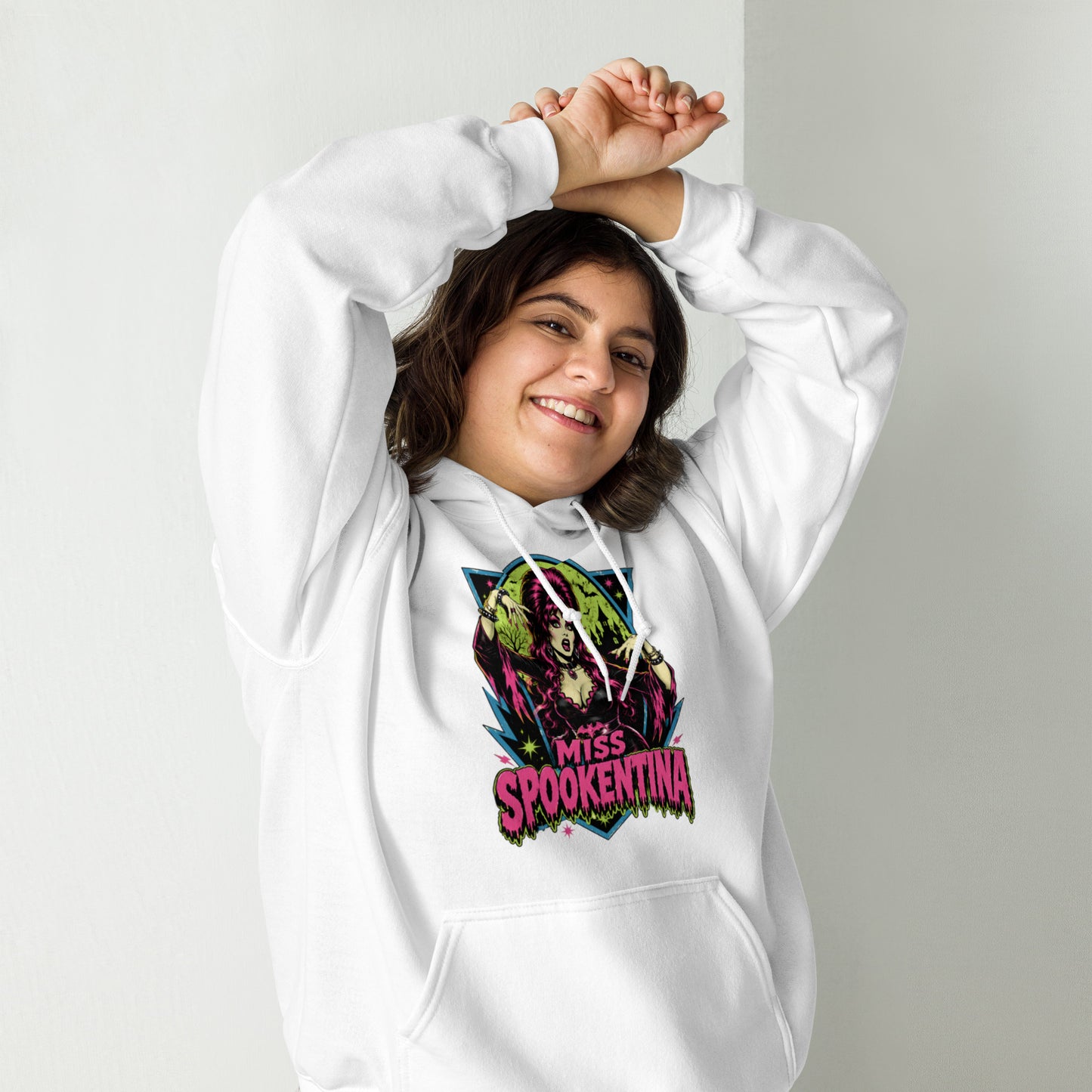 Female model posing outdoors in a heliconia pink unisex pullover hoodie featuring gothic floral sleeve accents