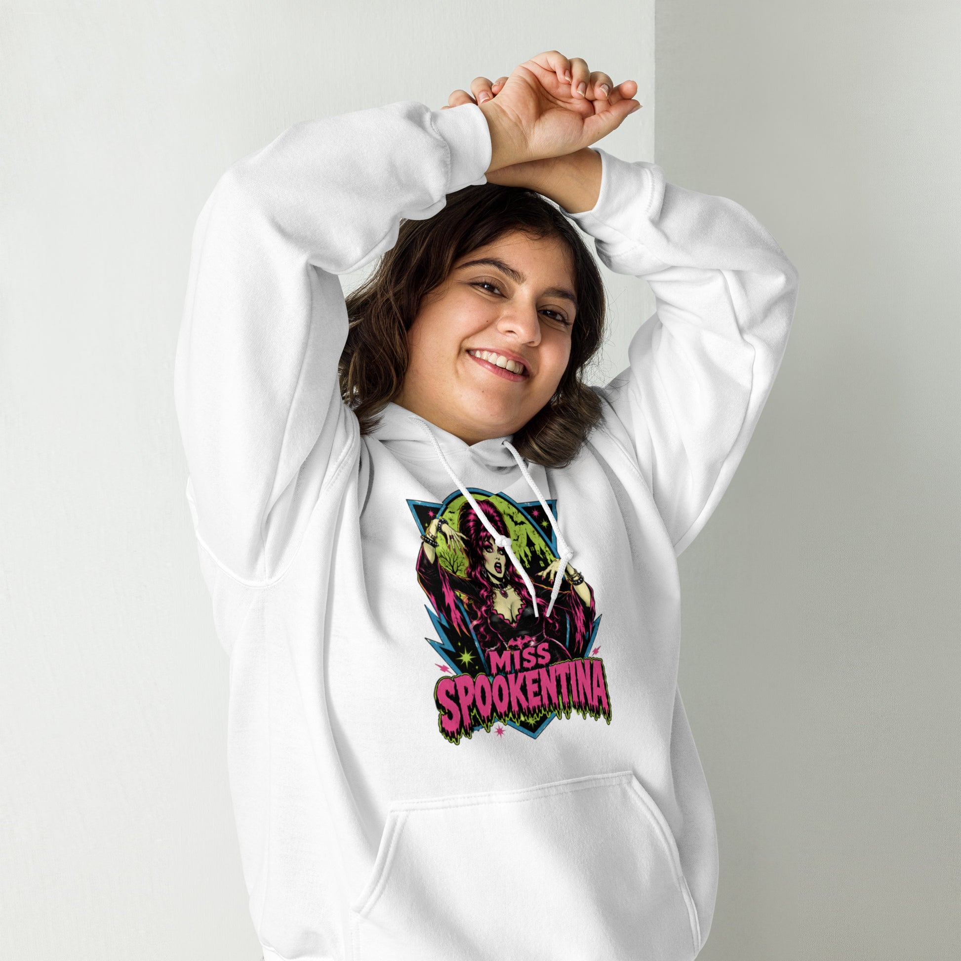 Female model posing outdoors in a heliconia pink unisex pullover hoodie featuring gothic floral sleeve accents
