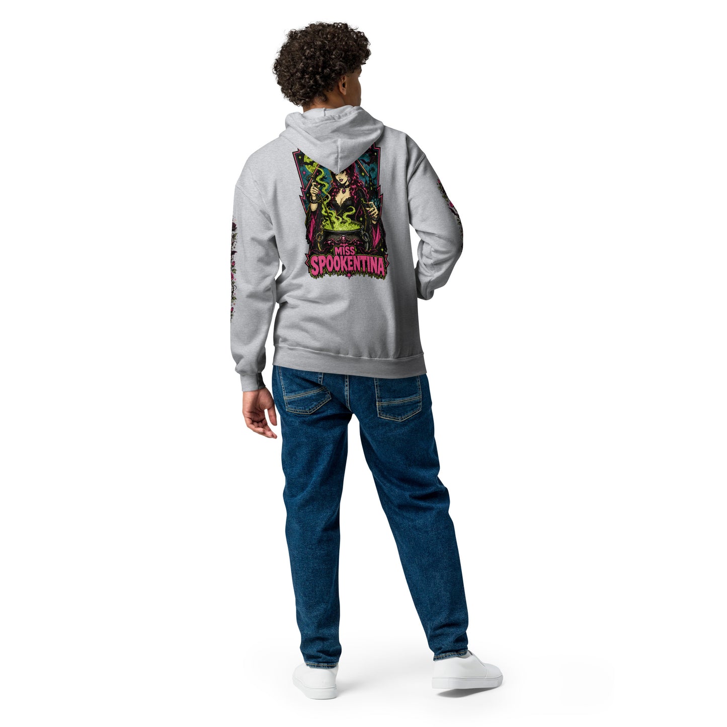 Back view of a male model wearing a sport grey unisex heavy blend zip hoodie featuring a vintage gothic witch brewing a cauldron with banner reading Miss Spookentina and floral sleeve print