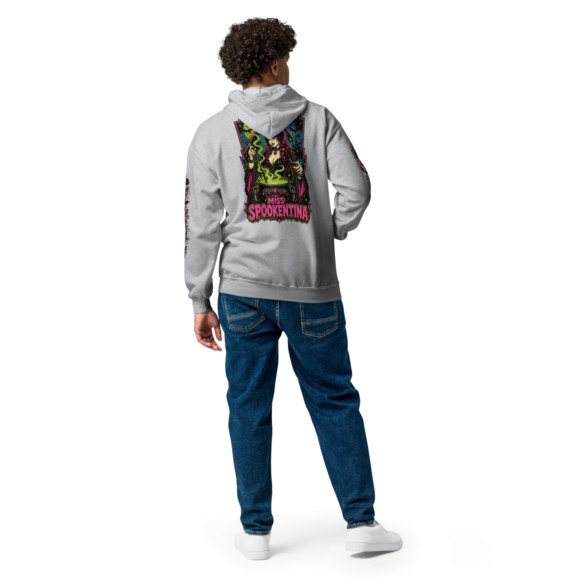 Back view of a male model wearing a sport grey unisex heavy blend zip hoodie featuring a vintage gothic witch brewing a cauldron with banner reading Miss Spookentina and floral sleeve print