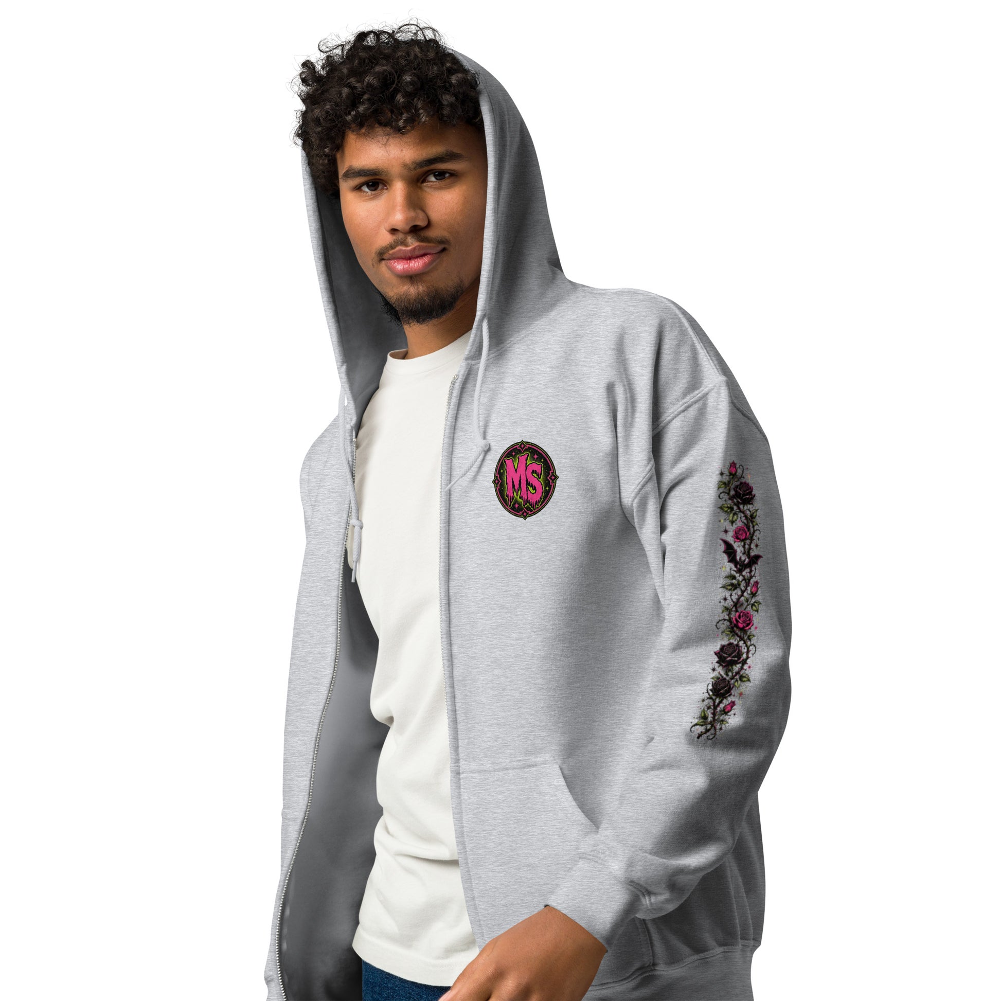 Male model wearing a sport grey unisex heavy blend zip hoodie with hood up featuring a pink circular chest emblem and floral sleeve print