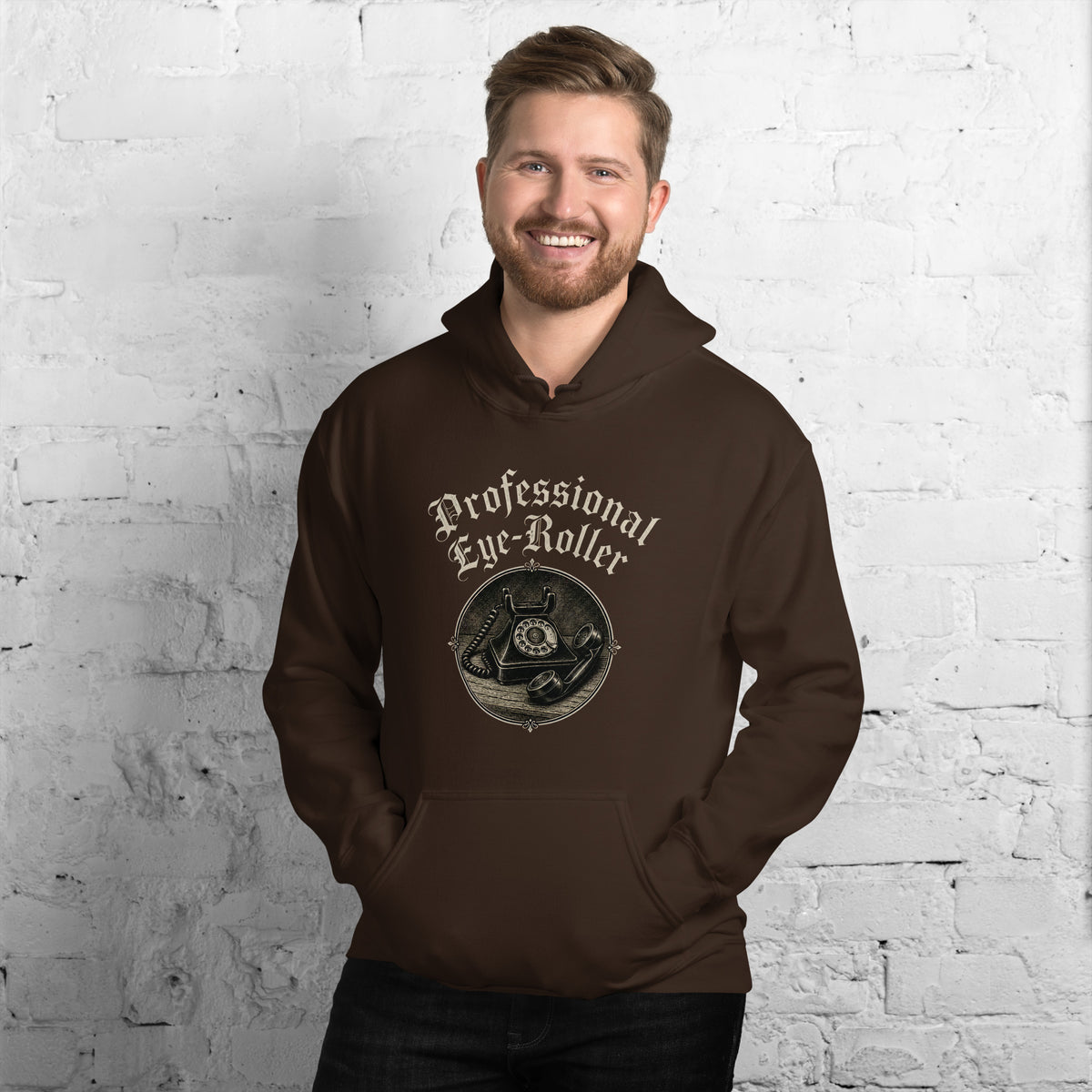 Front view of a smiling bearded man wearing a dark chocolate brown Professional Eye-Roller unisex hoodie