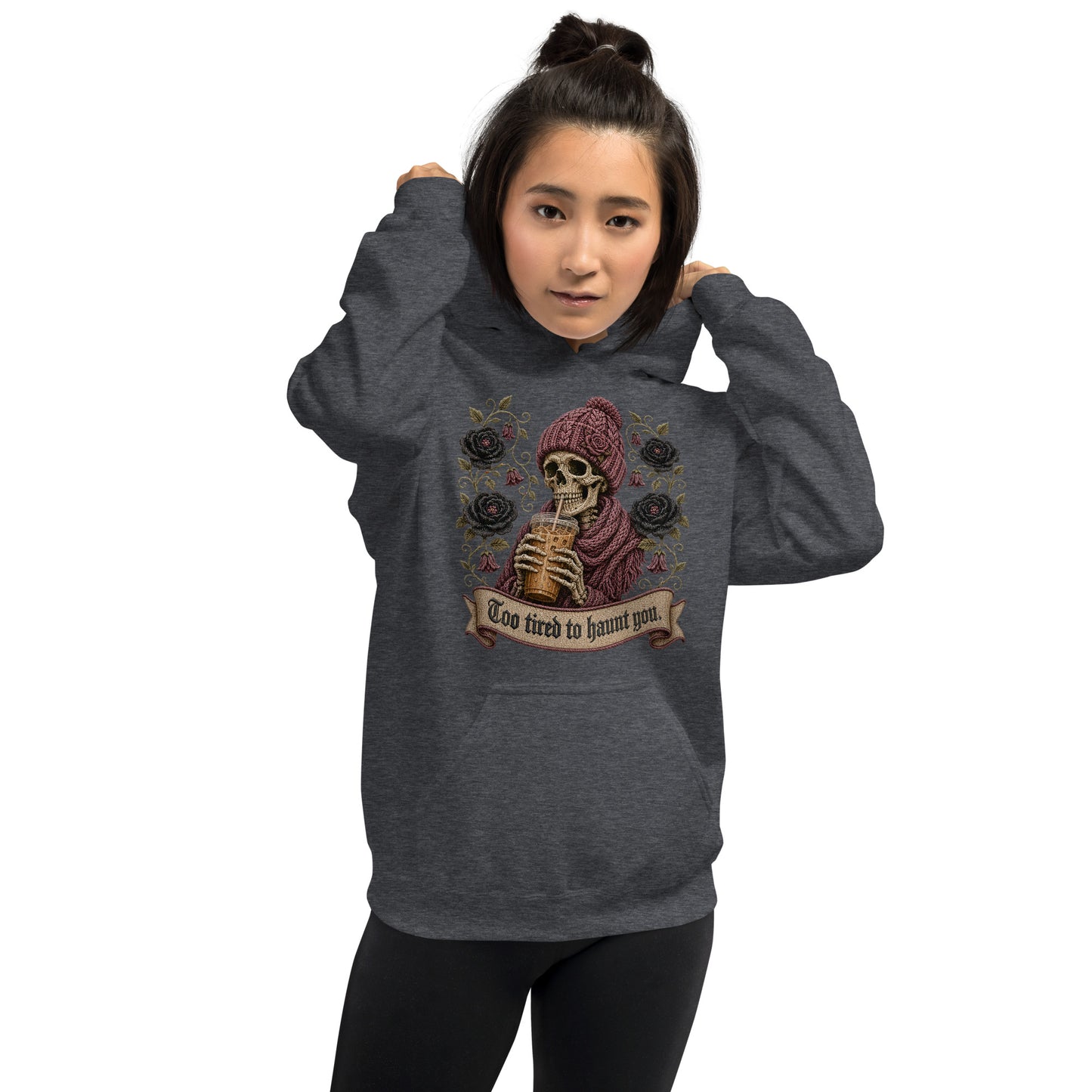 Female model wearing an oversized dark heather hoodie featuring gothic skeleton and iced latte artwork