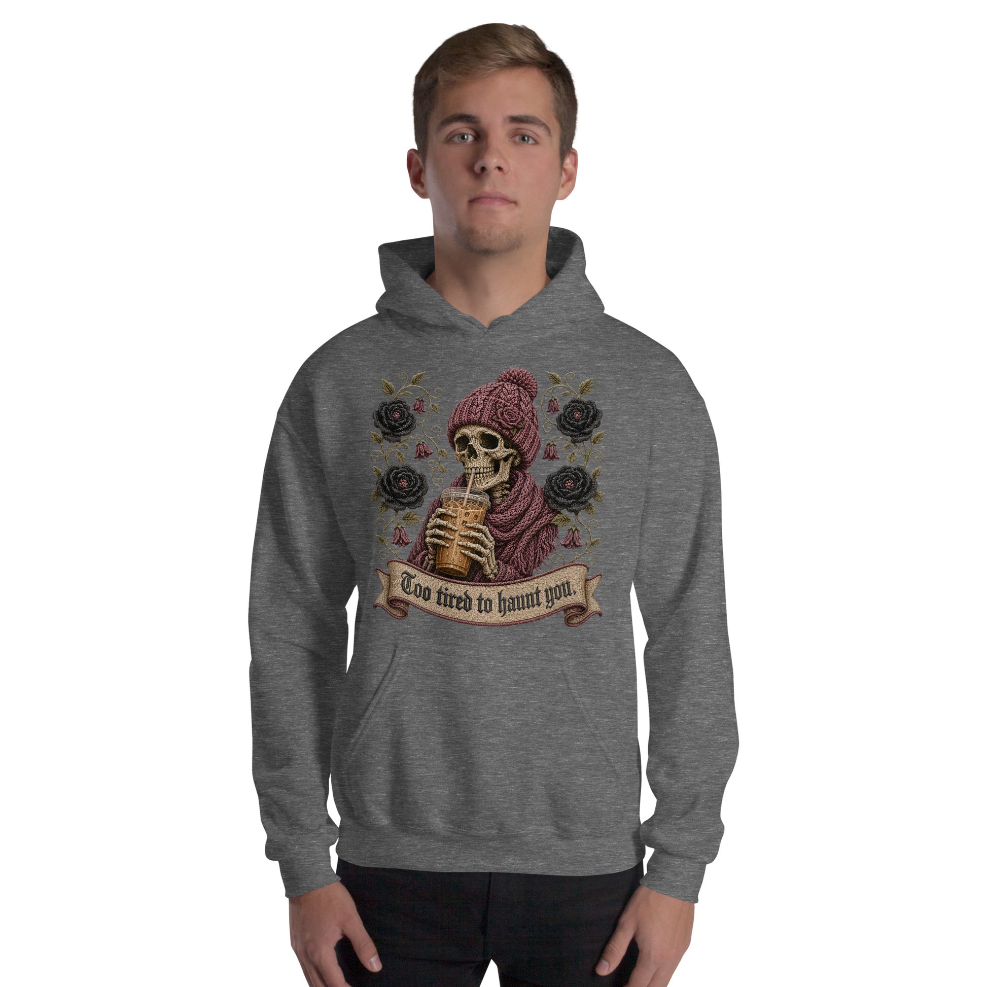 Male model wearing a dark heather gray graphic hoodie featuring a gothic skeleton drinking iced coffee