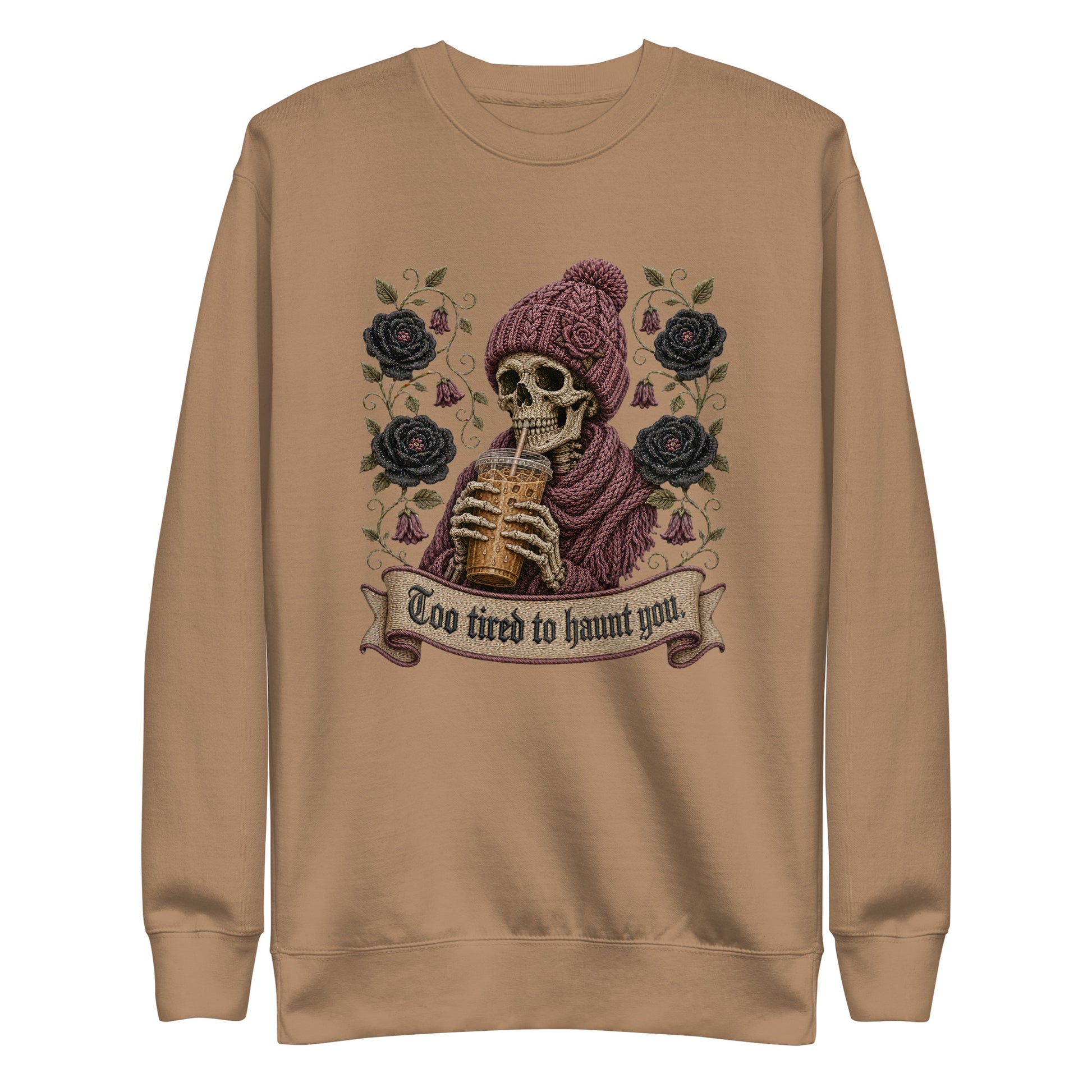 Latte beige unisex crewneck sweatshirt mockup featuring a gothic skeleton in a beanie drinking iced coffee with dark roses and banner reading "Too tired to haunt you"