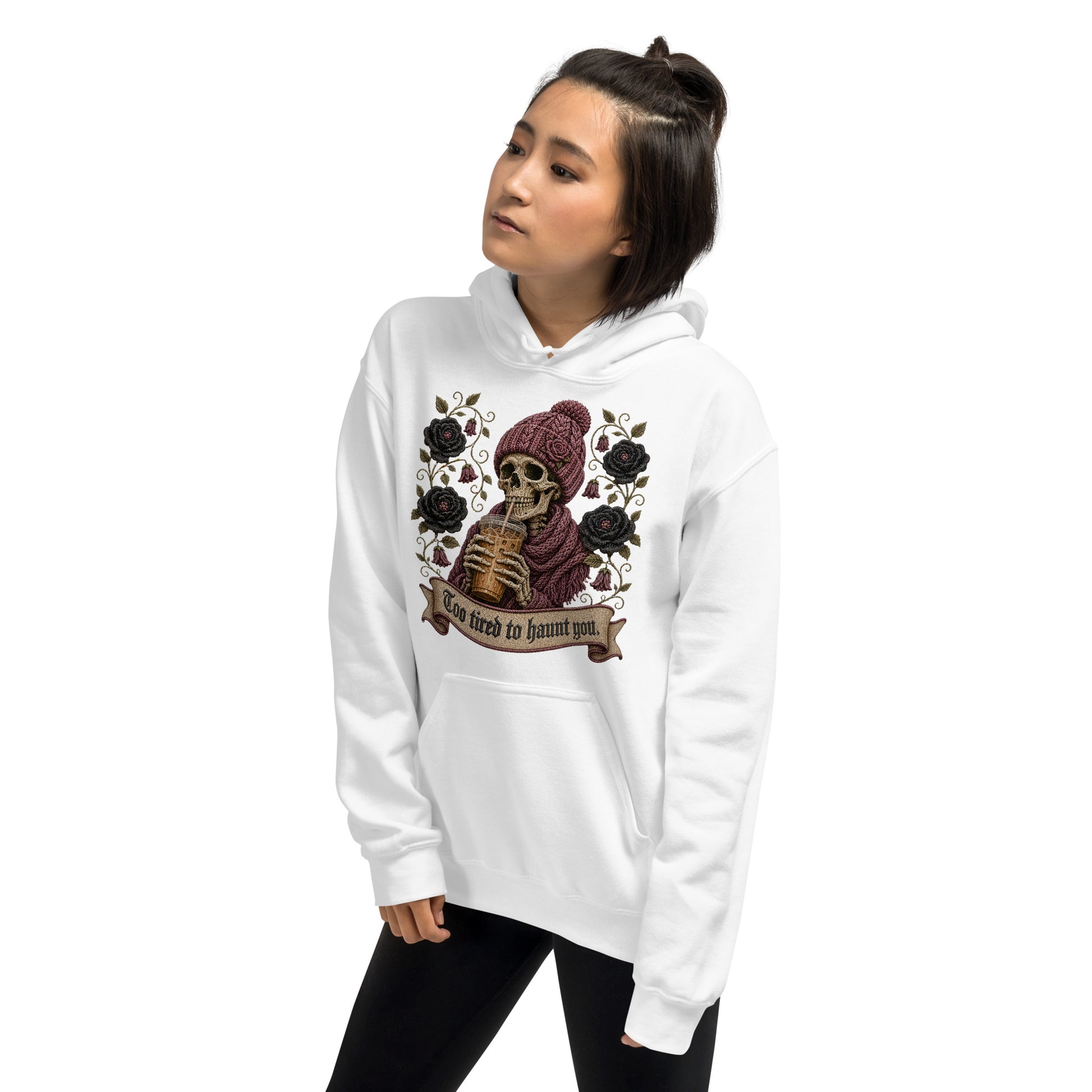 Female model wearing a white graphic pullover hoodie with gothic iced coffee skeleton design