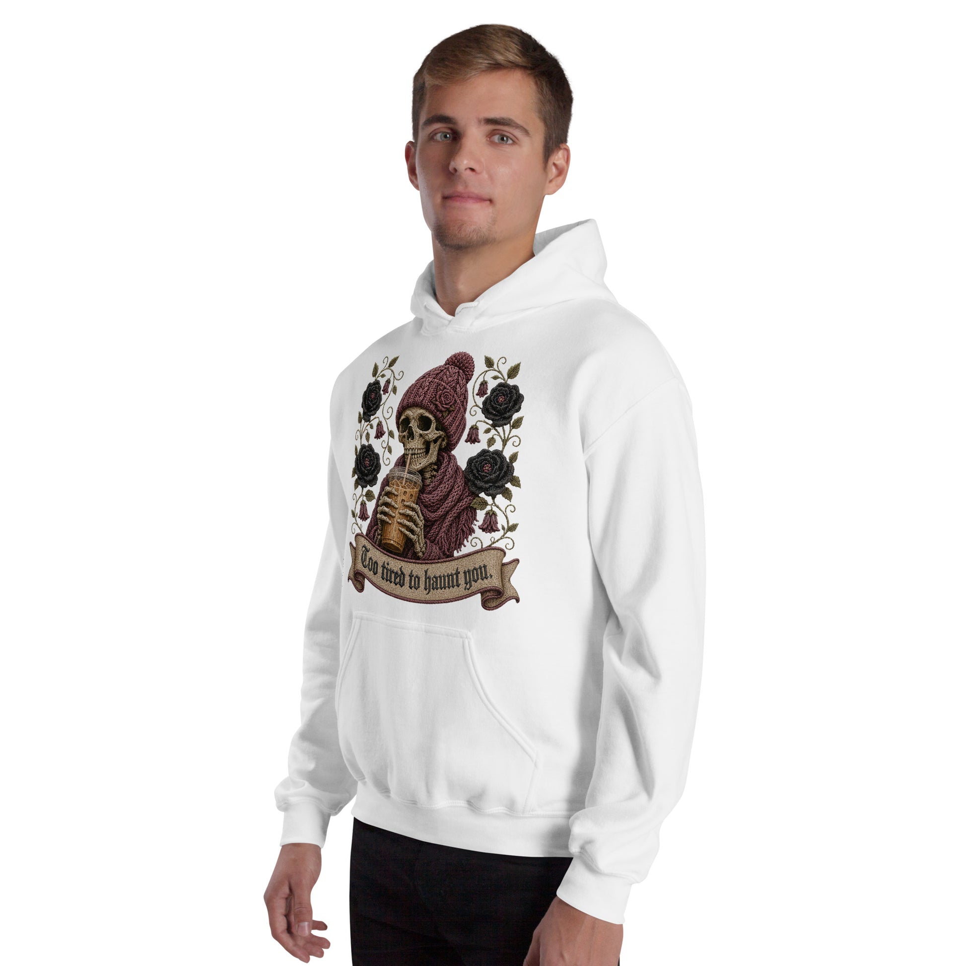 Male model wearing a white unisex hoodie with Too Tired to Haunt You skeleton iced coffee graphic