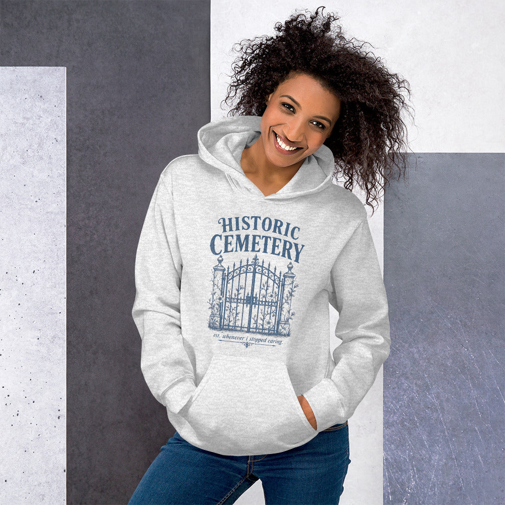 Model wearing oversized vintage gothic cemetery gates hoodie styled for fall dark academia aesthetic.