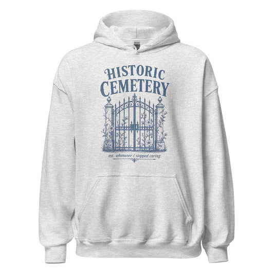 Historic Cemetery Gates graphic printed on the front of an ash gray unisex pullover hoodie.