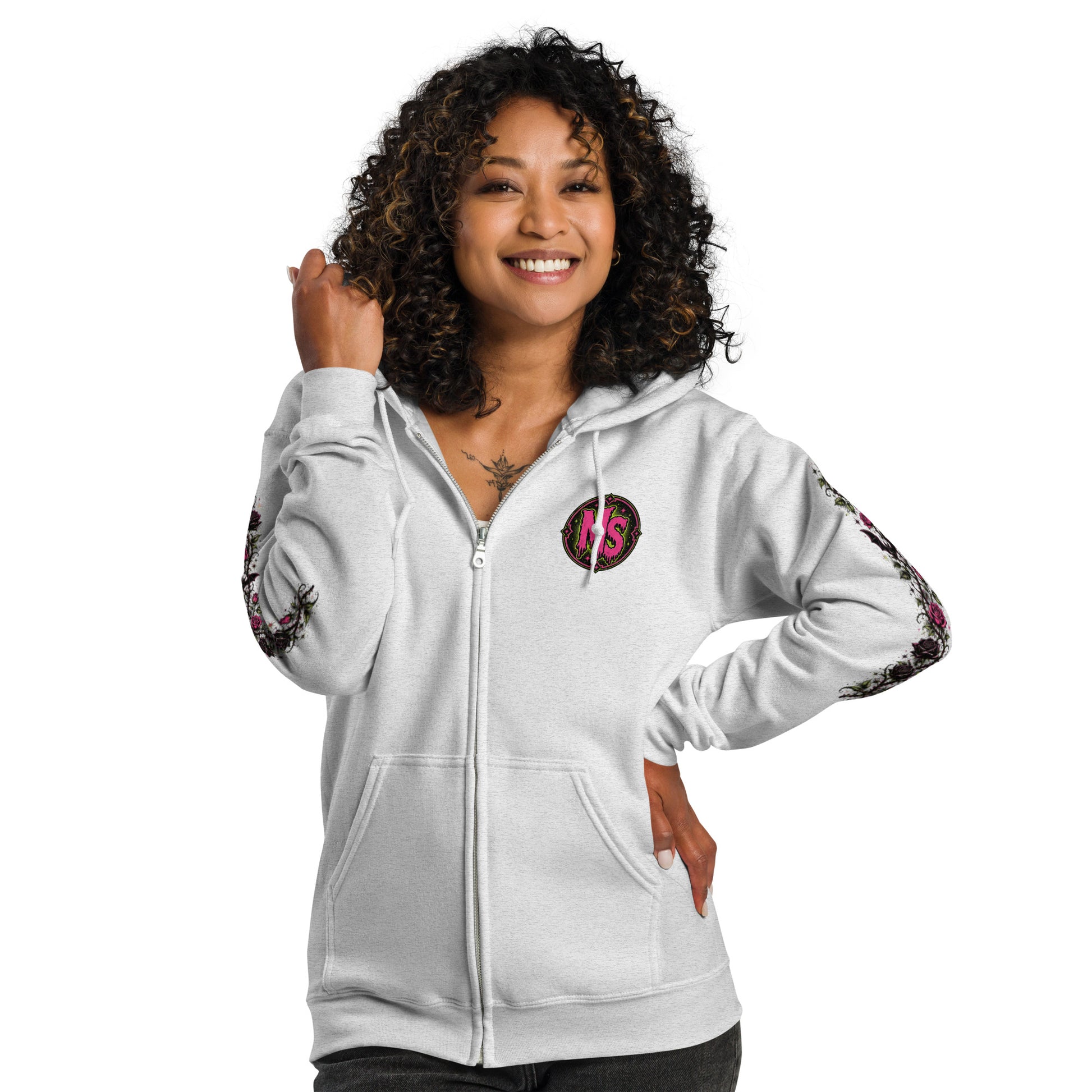 Back view of a female model wearing a black unisex heavy blend zip hoodie featuring a vintage gothic witch brewing a cauldron with banner reading Miss Spookentina and floral sleeve prints